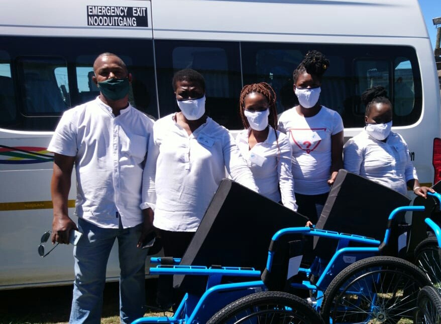 SDA team members with wheelchairs donated by DPSA, delivered with the Department of Social Development